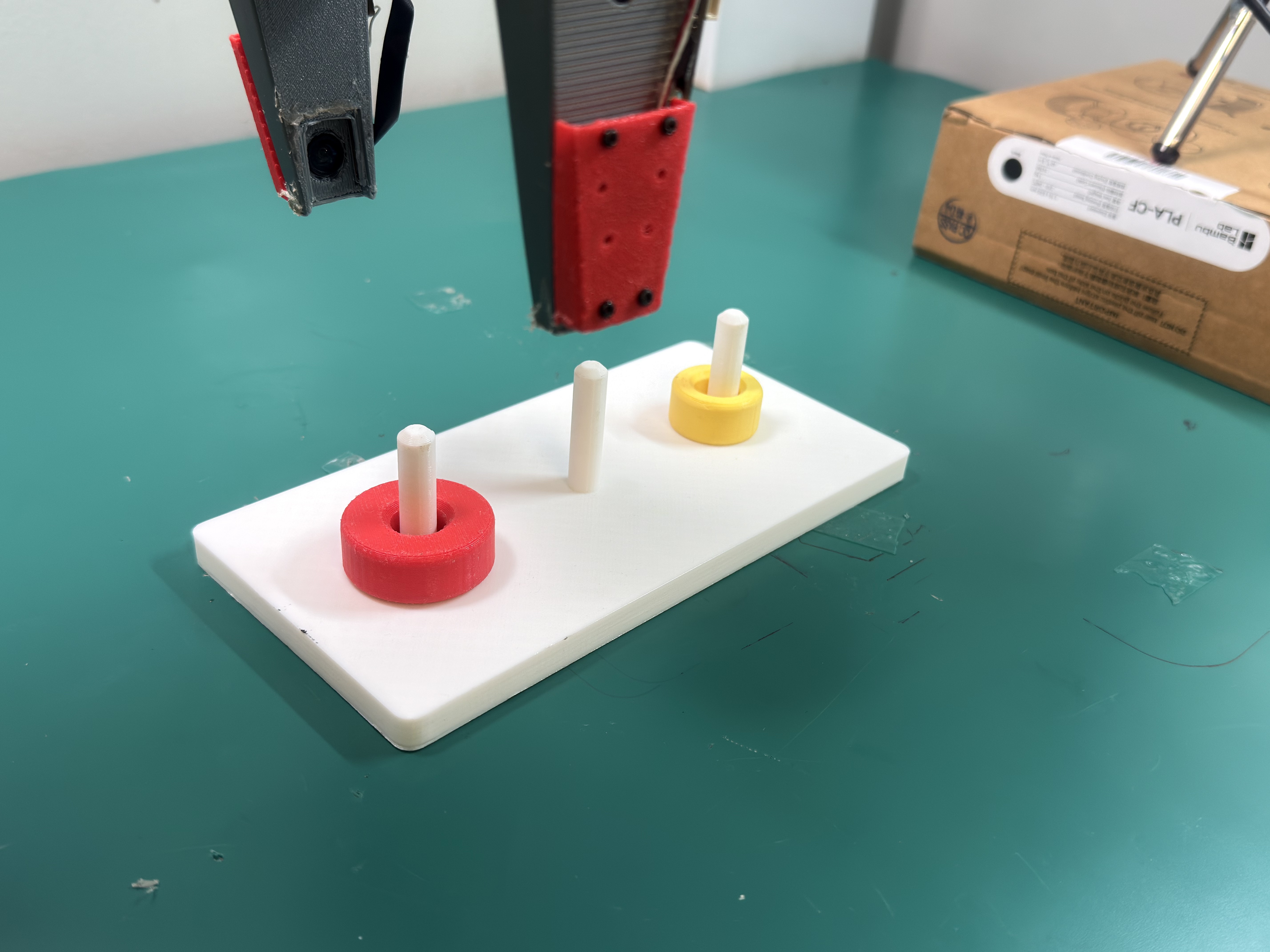 Robot completing a Tower-of-Hanoi assembly task.