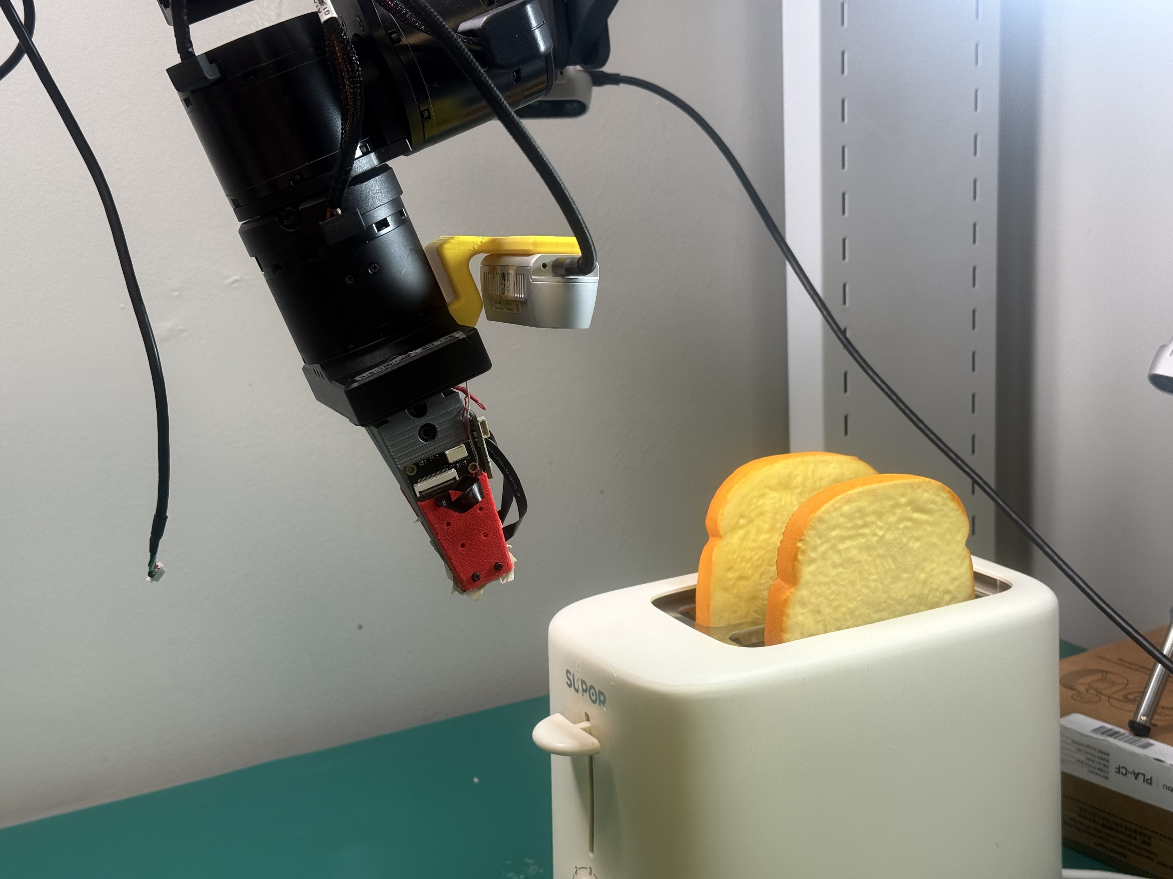 Robot pressing bread into a toaster for the pushing task.